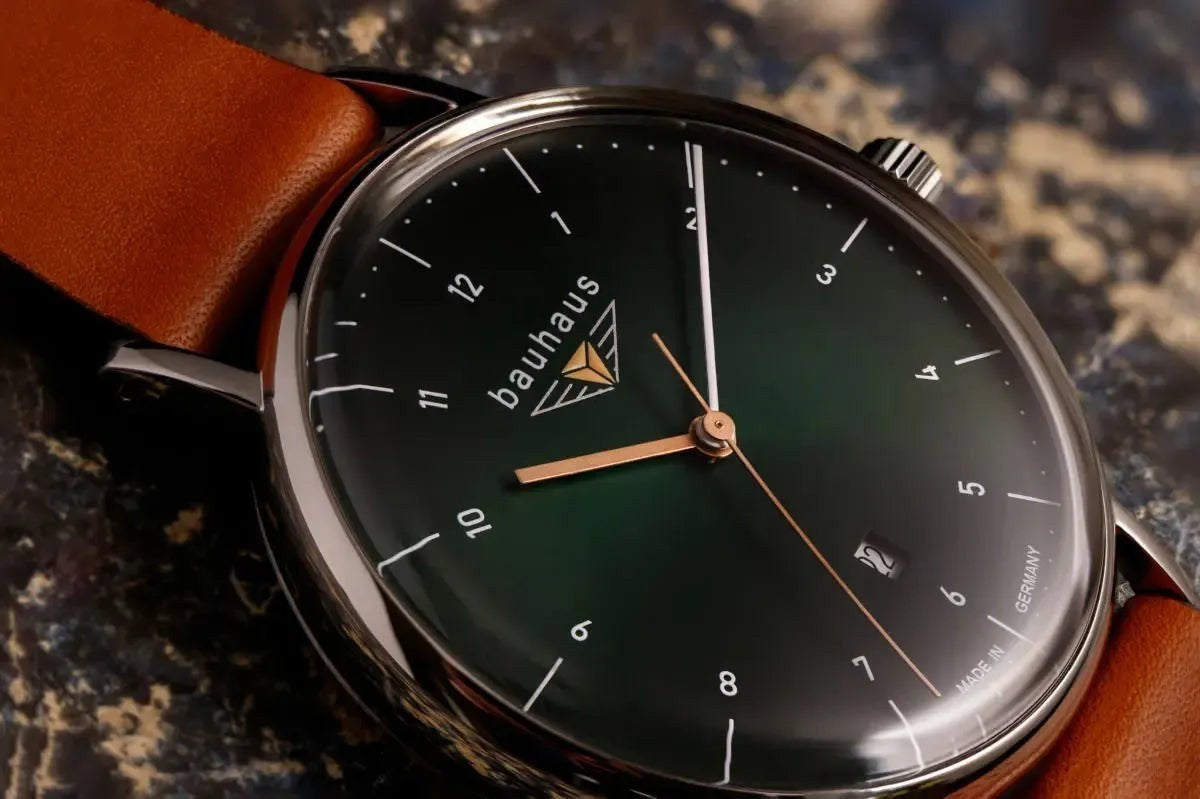 Bendixen-Braun Bauhaus men's watch with dark green dial, cognac leather strap, date window, and two-tone hands.