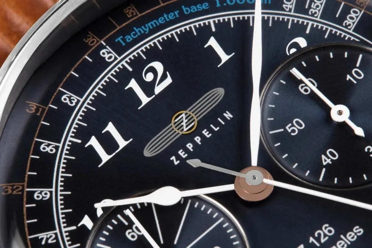 Bendixen-Braun Zeppelin men's chronograph watch with polished stainless steel case, blue dial, and tachymeter.