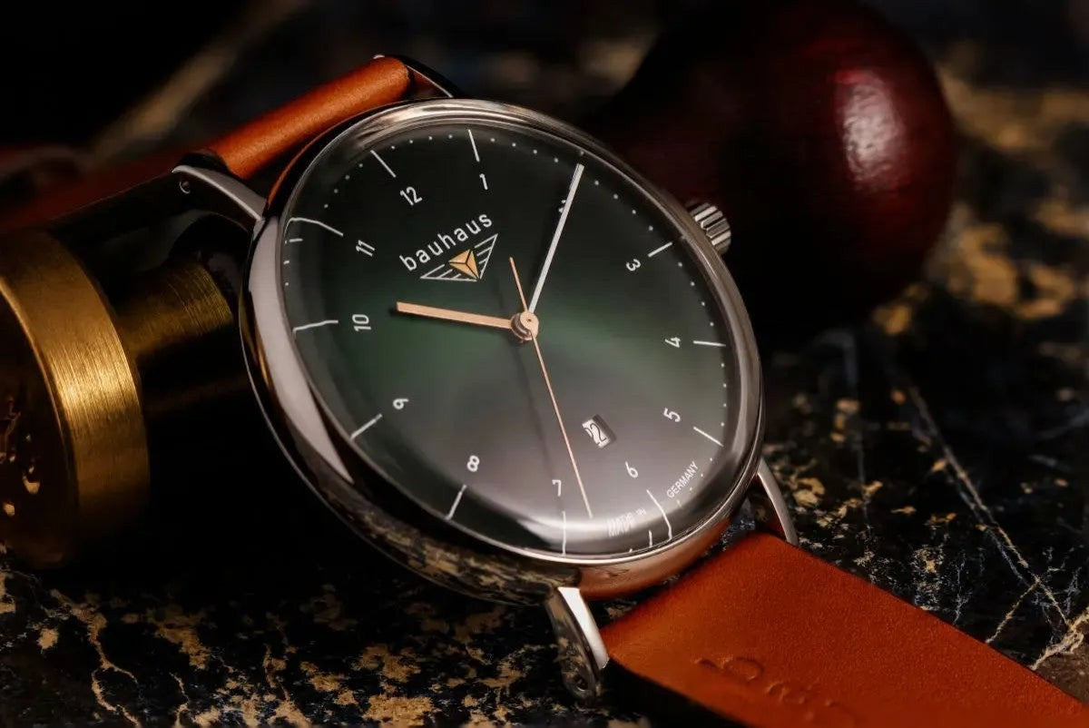 Bendixen-Braun Bauhaus men's watch with dark green dial, cognac leather strap, date window, and two-tone hands.