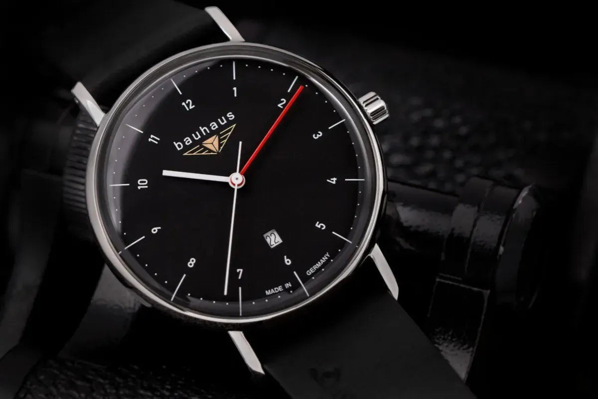 Bendixen-Braun Bauhaus men's watch with black dial, stainless steel case, and red second hand.