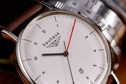 Bendixen-Braun Bauhaus men's watch with white dial, date window, red seconds hand, and brown leather strap.