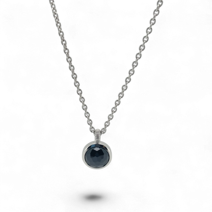 Bendixen-Braun silver necklace with rhodium finish and a round, faceted black stone pendant. Adjustable chain.