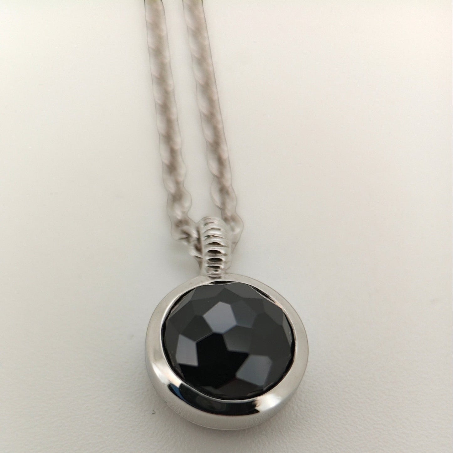 Bendixen-Braun silver necklace with rhodium finish and a round, faceted black stone pendant.