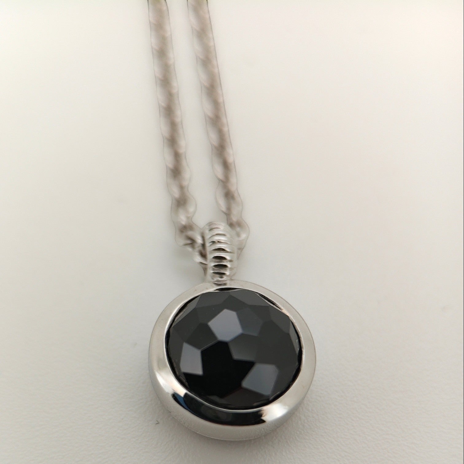 Bendixen-Braun silver necklace with rhodium finish and a round, faceted black stone pendant.