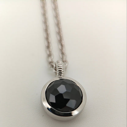 Bendixen-Braun silver necklace with rhodium finish and a round, faceted black stone pendant.
