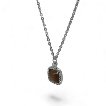 Bendixen-Braun rhodium-plated silver necklace with brown faceted glass pendant surrounded by cubic zirconia.