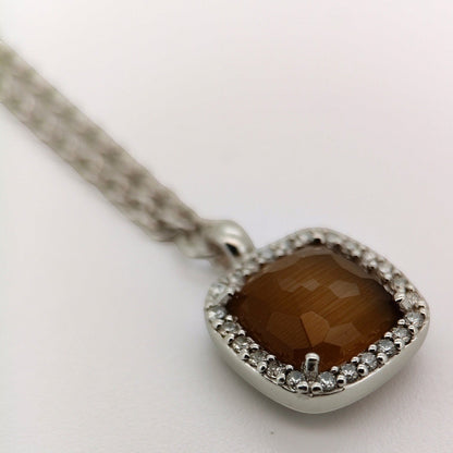 Bendixen-Braun rhodium-plated silver necklace with brown faceted glass pendant surrounded by cubic zirconia.